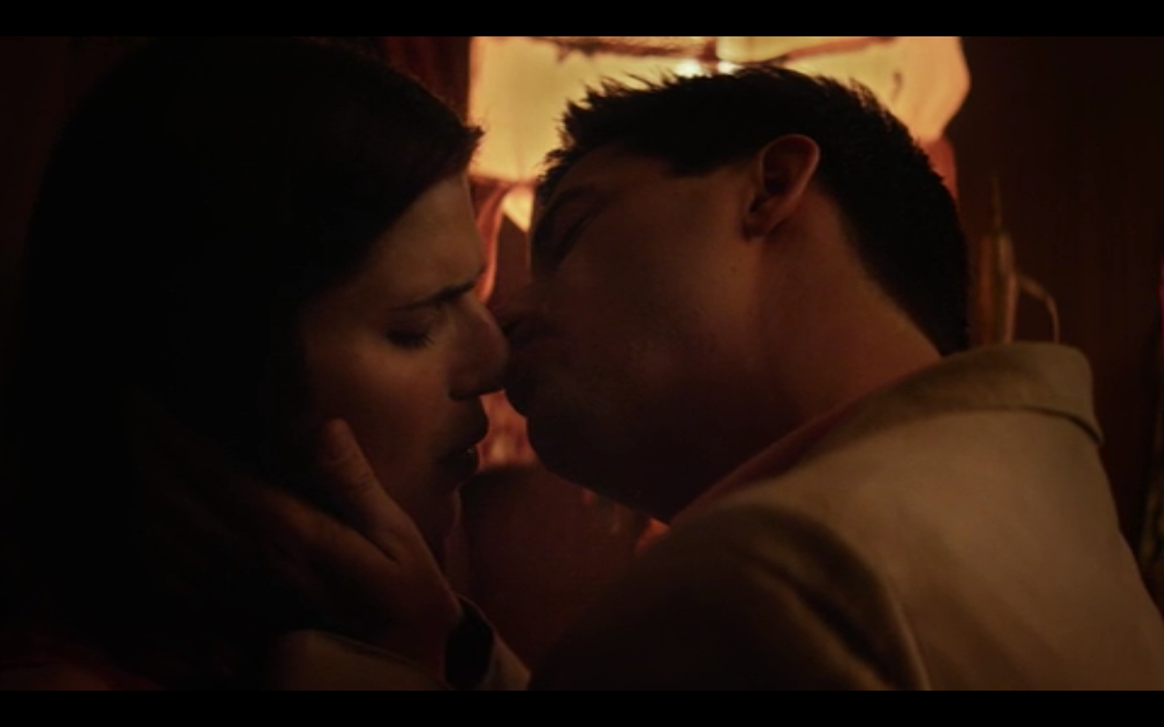 A man kisses a woman's nose.