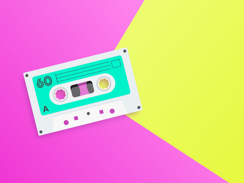 A cassette tape rests on a bright pink and yellow background.